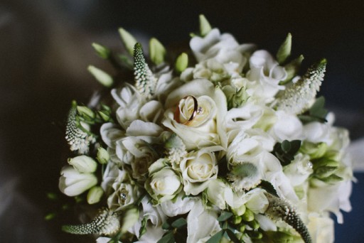 Photo of a wedding bouquet made up of white flowers and green foliage