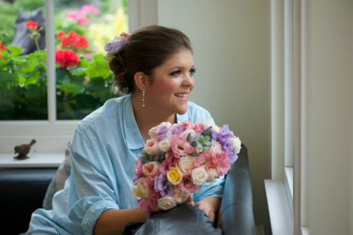 Bride on morning of wedding with her bouquet of flowers
