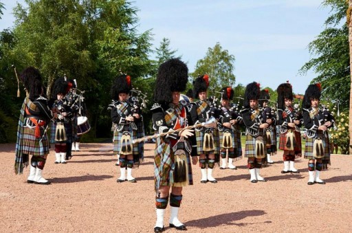 Photo of a pipe band in full Highland regalia playing a beating retreat