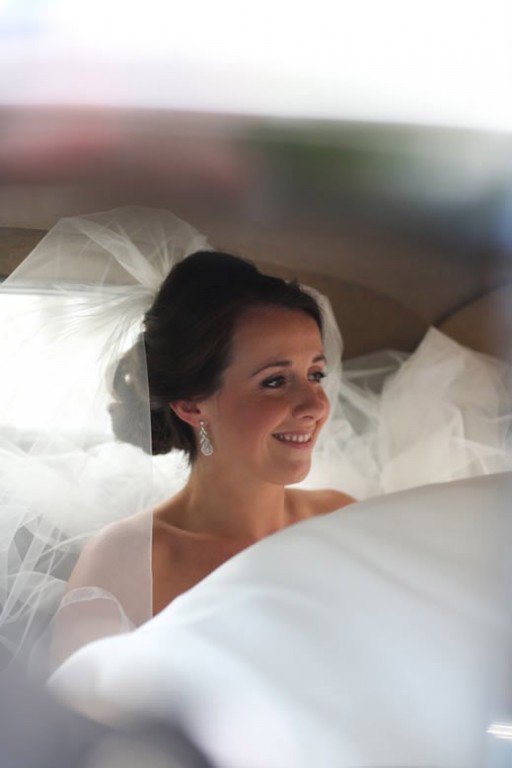 Photo of bride sitting in wedding car