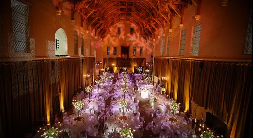 Photo of grand hall with vaulted ceiling set up for a wedding reception