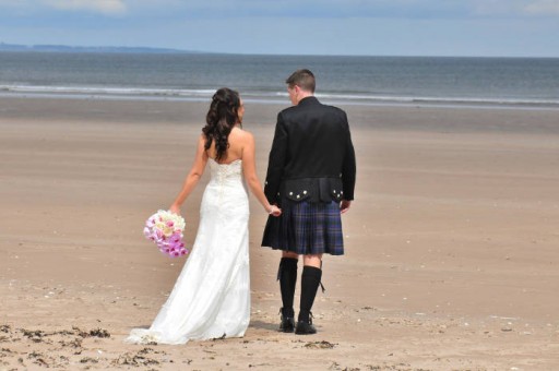 Photo of a bride and groom on the West Sands at St Andrews