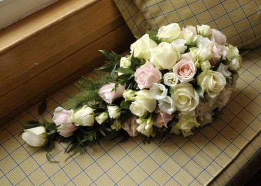 Photo of wedding bouquet with pale ivory, pink and white flowers